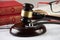 Law books with wooden judges gavel and medical stethoscope