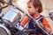 Law for child drivers under 18 concept. Portrait of cute little biker child girl sitting on a motorcycle