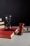 Law code. Hourglass on red book and judge gavel, vertical image