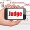 Law concept: Hand Holding Smartphone with Judge on display