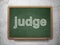Law concept: Judge on chalkboard background