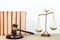 Law concept - Open law book, Judge\\\'s gavel, scales on table in a courtroom or law enforcement office