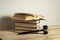 Law concept. Wooden judge gavel with law books on the table in a courtroom or enforcement office.