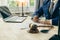 Law and Justice Lawyer working with documents and laptop, hammer, scale at wooden table in office Close-up