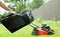 Lawn grass mowing. Washing the lawn mower\'s grass catcher with water. Splashes of water A gas-