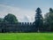 Lawn for grazing horses in the courtyard of a medieval castle. Lawn and pasture. Old architecture. Beautiful place. Lawn with