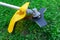 Lawn mower on a background of green grass. Trimmer for cutting green grass lawns. Trimmer knife on a background of green grass.