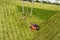 Lawn mower cutting grass on green field in yard. Mowing gardener care work tool