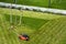 Lawn mower cutting grass on green field in yard. Mowing gardener care work tool