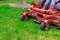 Lawn mower cutting green grass in backyard