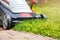 Lawn mower in front of a mown green lawn