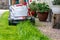 Lawn mower in front of a mown green lawn