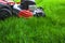 Lawn mower in green grass