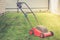 Lawn mower on a green lawn/mowing lawn on the grass in the cottage yard