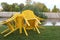 On the lawn near the river there is a table with sloping chairs after the rain