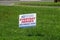Lawn sign on the green grass outside of a post office that says that postal workers are everyday heroes that deliver hope