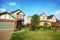 Lawn with trees and shrubs between two cottages