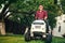 Lawncare concept - Smiling worker using ride on grass mower
