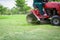 Lawnmower cutting overgrown grass