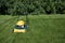 Lawnmower mowing grass with space for copy