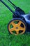 Lawnmower with yellow wheel