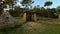 Lawns with old stone architecture and sunset trees in Parque Periurbano De San Roque in Spain