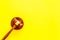 Lawyer or attorney concept. Judge gavel on yellow background top view copy space