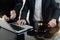 Lawyer businessman and two business partners working together in office. Businessmen sitting at desk and making notes