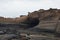 A layer of black rock stone near the sea