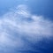 layer of broken stratus clouds under a deep blue sky