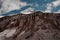 Layer brown mountain hill with the snow remnants on the bottom