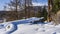 A layer of pure untouched snow on the ground and the trunk of a fallen tree