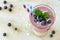 Layered blueberry and coconut smoothie, downward view over marble