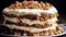 A layered carrot cake with cream cheese frosting and chopped nuts on top