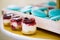 Layered cheesecake, biscuit and jam dessert in jars, wedding candy bar