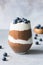 Layered chia pudding or healthy breakfast parfait with chocolate and yogurt