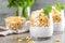 Layered chia pudding parfait with banana, sweet wheat with honey and yogurt