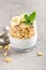 Layered chia pudding parfait with banana, sweet wheat with honey and yogurt