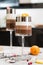 Layered chocolate desserts in glasses. Slices of mandarine on a top of sweet. Selective focus