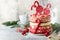 Layered Christmas gingerbread cake decorated with red Lolli pops, colored confetti on white cake stand, Christmas balls, fir