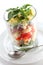 Layered cobb salad in a glass cup