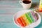 Layered delicious homemade rainbow cake with cup of coffee