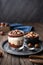 Layered dessert with chocolate mousse, cream cheese and whipped cream mixed with chestnut puree, topped with hazelnuts in a glass