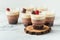 Layered dessert Trifles in a transparent glass. Sponge biscuit and three chocolate mousse layers. Chocolate souffle trifle cake