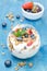 Layered dessert with yogurt, granola, fresh berries and a bowl