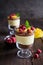 Layered mango dessert with cream cheese, crushed biscuits and freeze dried raspberries