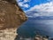 A layered piece of rock protruding above the sea