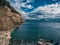 A layered piece of rock protruding above the sea