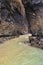 Layered rocks of the beach of Cathedrals in summer cloudy day, a