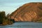 Layered rocks on the hillside above the river.